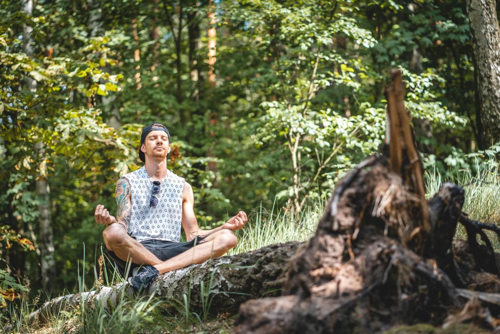 man practicing yoga in nature