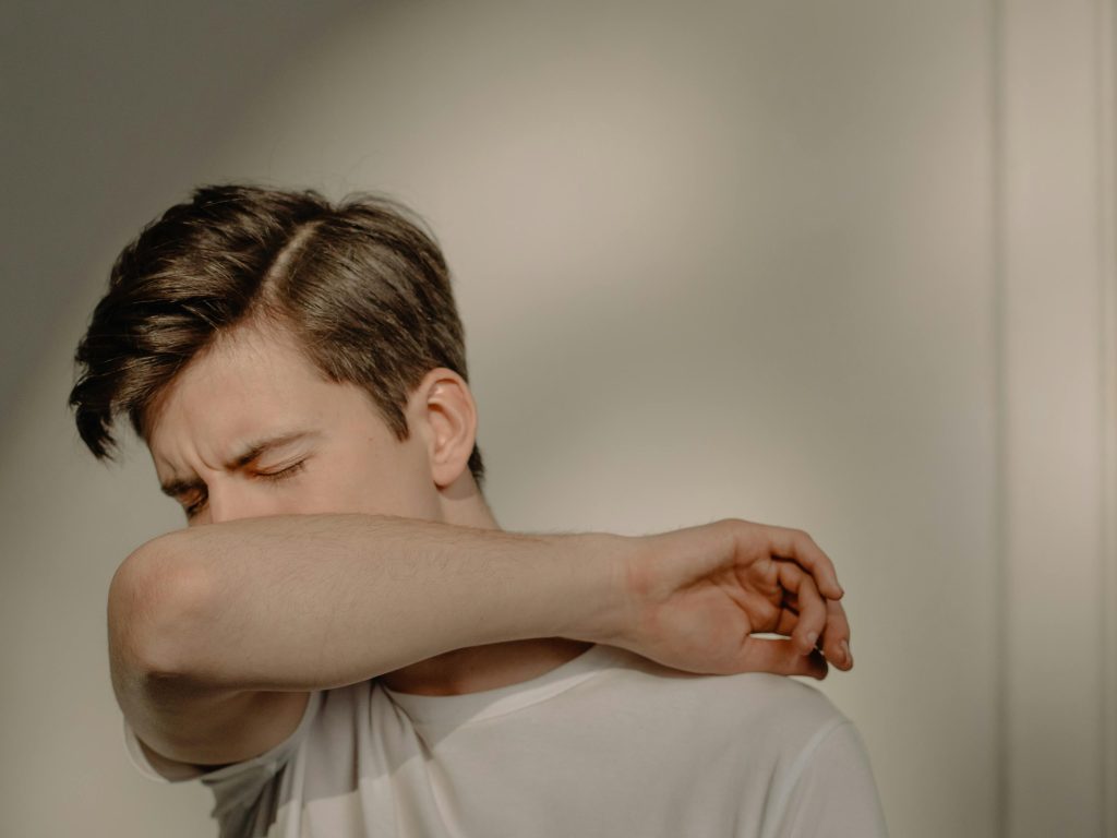 a man sneezing - Acupuncture and Seasonal Allergies