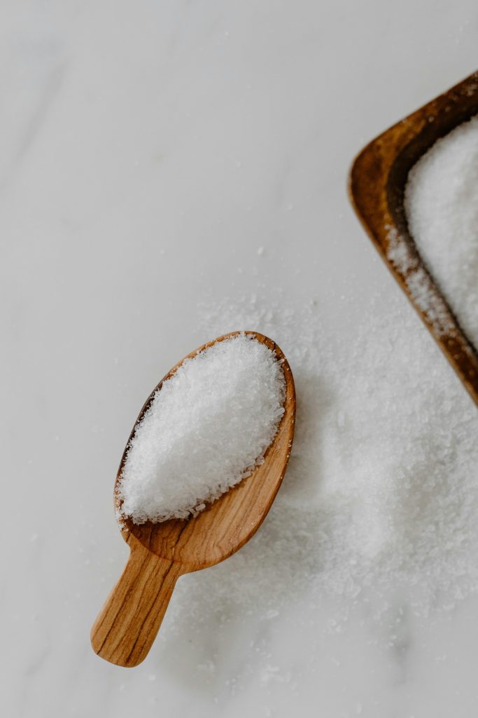 Wooden spoon holding iodized salt, a simple way to support iodine and fertility through diet.