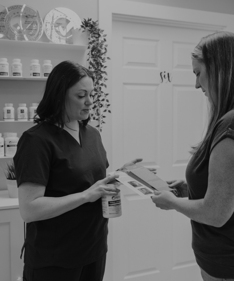 Acupuncturist discussing low ovarian reserve treatment options with a patient during a fertility consultation.