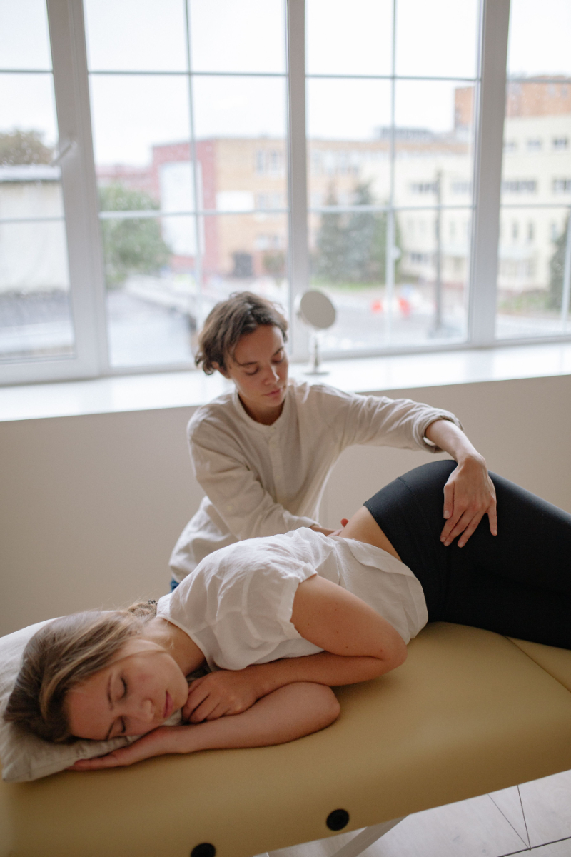 Woman relaxing at home in natural light, representing self-care support for acupuncture and fibroids.